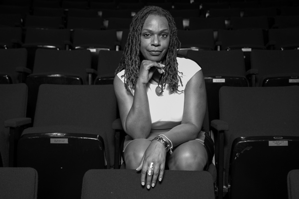 Satori Shakoor poses in an the front row of an empty theater.