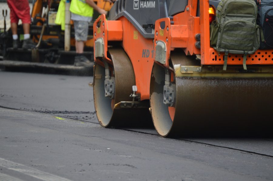 A road crew with heavy machinary is fixing the roads
