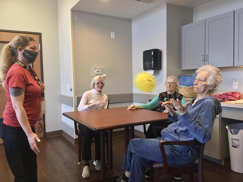 Jamie Capp helps residents at New Hope Valley