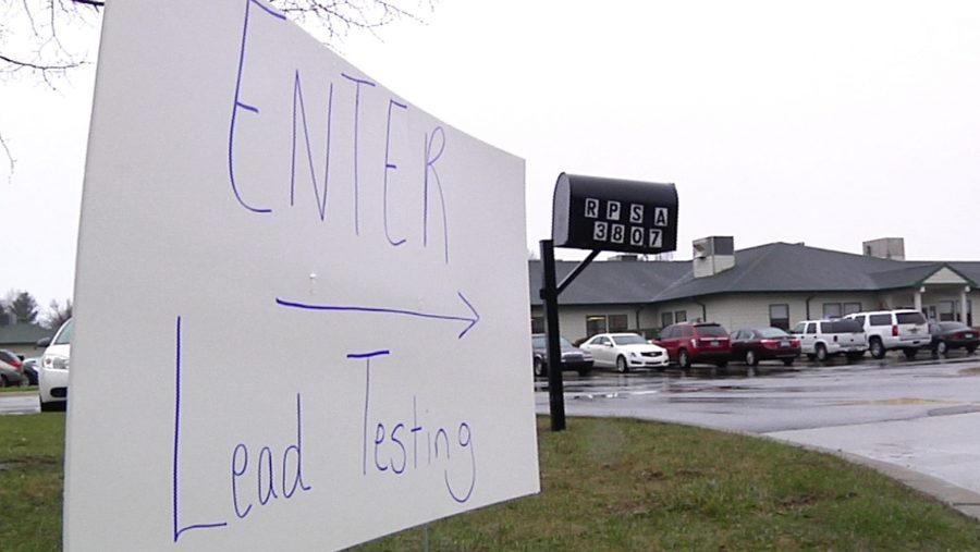 This Thursday, March 24, 2016, image from video shows a hand-written sign placed at the entrance to a lead-testing clinic in Flint, Mich.